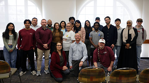 Group photo of diverse SDSU students and presenters gathered after the engaging "AI Isn’t the Future—You Are" session during SDSU's OpenAI Day event.